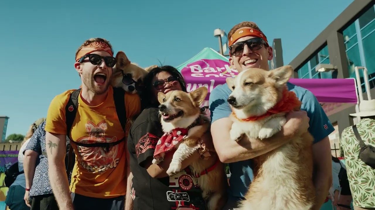 Friends holding their corgis at Chonkfest